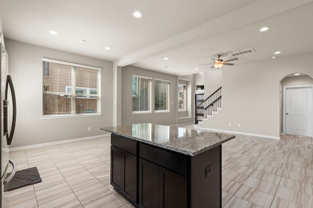 2531 Terrace Point Dr, Missouri City, TX 77459 - kitchen featuring freestanding refrigerator, recessed lighting, arched walkways, light tile patterned flooring, and ceiling fan