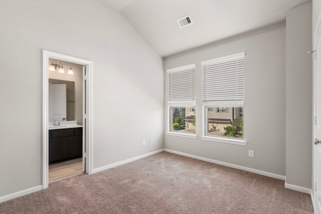 2531 Terrace Point Dr, Missouri City, TX 77459 - unfurnished bedroom featuring light carpet, lofted ceiling, baseboards, and ensuite bathroom
