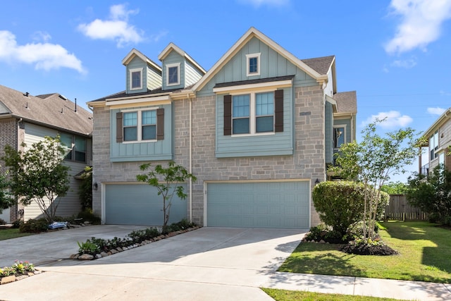 2531 Terrace Point Dr, Missouri City, TX 77459 - view of front of home featuring board and batten siding, stone siding, a garage, and concrete driveway