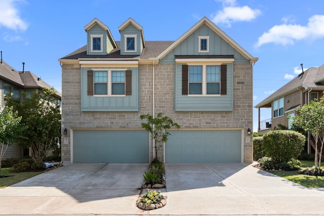 2531 Terrace Point Dr, Missouri City, TX 77459 - view of front of house featuring a garage, board and batten siding, driveway, and stone siding