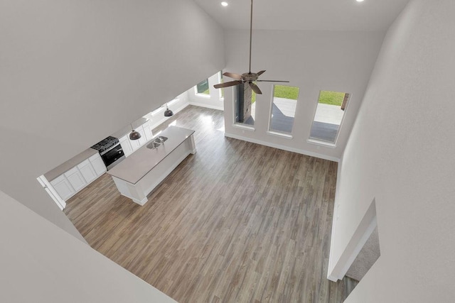 21611 Elmheart Dr, New Caney, TX 77357 - unfurnished living room with wood finished floors, recessed lighting, and ceiling fan