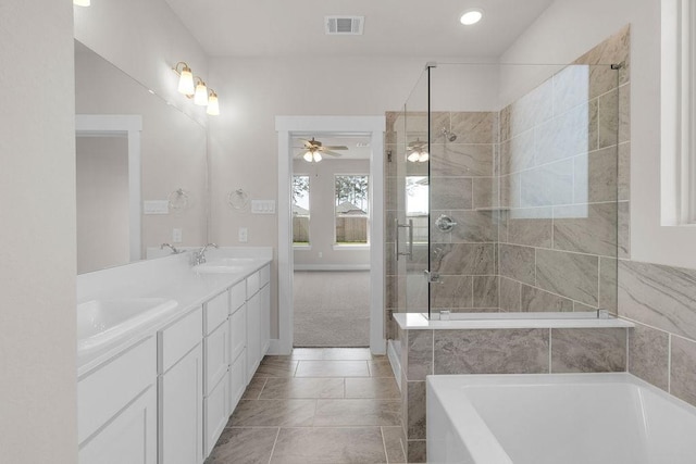 21611 Elmheart Dr, New Caney, TX 77357 - full bath featuring a garden tub, double vanity, ceiling fan, tiled shower, and recessed lighting