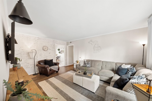 living room with wood finished floors, crown molding, and baseboards