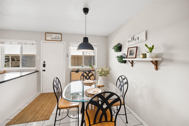 dining area featuring baseboards and light tile patterned floors
