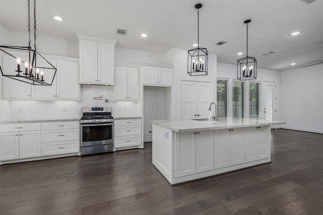 2305 Langston St, Houston, TX 77007 - kitchen with gas stove, a chandelier, white cabinets, tasteful backsplash, and a sink