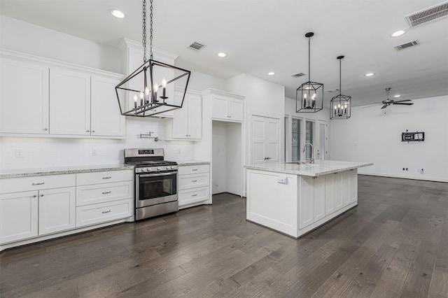2305 Langston St, Houston, TX 77007 - kitchen with stainless steel range with gas cooktop, a chandelier, a sink, white cabinetry, and recessed lighting