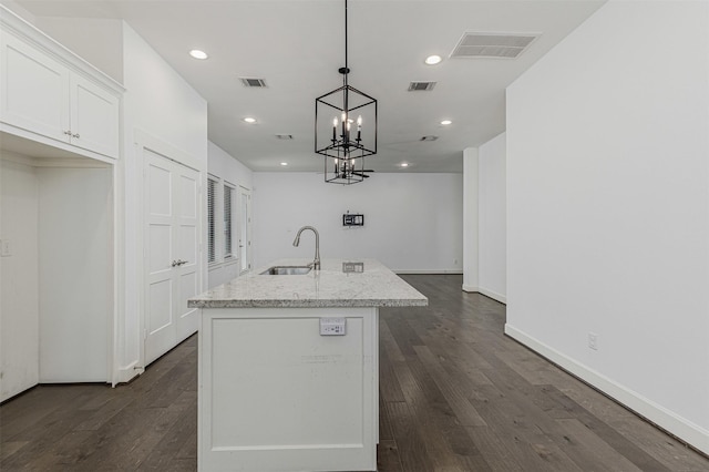 2305 Langston St, Houston, TX 77007 - kitchen featuring a sink, dark wood finished floors, a center island with sink, white cabinets, and recessed lighting