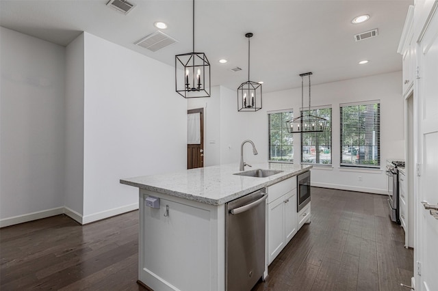 2305 Langston St, Houston, TX 77007 - kitchen featuring stainless steel appliances, a sink, a chandelier, dark wood-type flooring, and white cabinetry