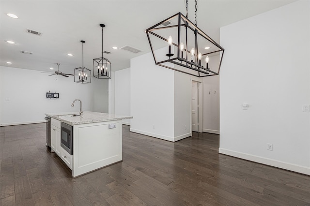 2305 Langston St, Houston, TX 77007 - kitchen featuring stainless steel microwave, ceiling fan, white cabinets, dark wood-style flooring, and recessed lighting