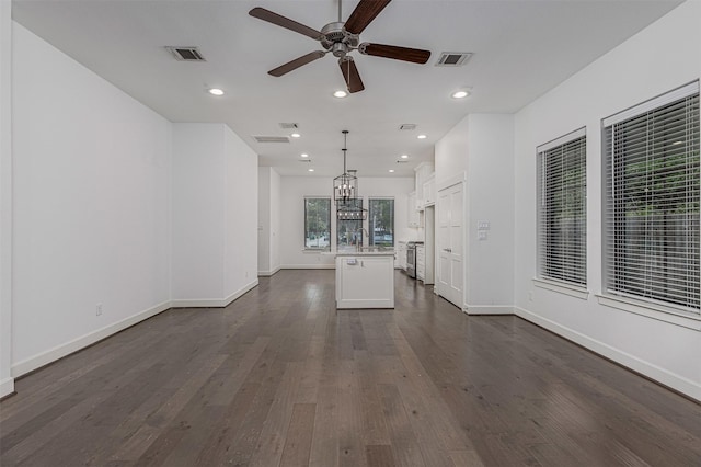 2305 Langston St, Houston, TX 77007 - unfurnished living room with a ceiling fan, dark wood-style flooring, a sink, baseboards, and a chandelier