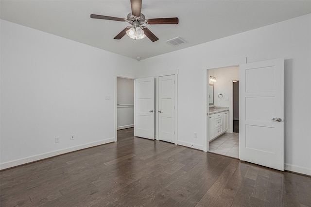 2305 Langston St, Houston, TX 77007 - unfurnished bedroom featuring wood finished floors, baseboards, connected bathroom, and ceiling fan