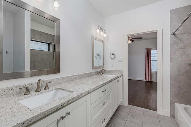 2305 Langston St, Houston, TX 77007 - bathroom featuring double vanity, a ceiling fan, tile patterned floors, and tub / shower combination