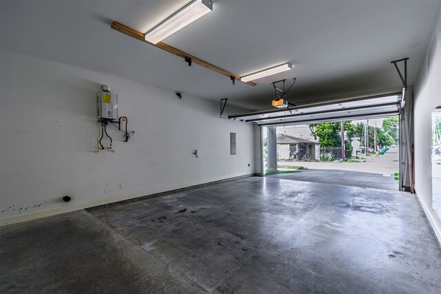 2305 Langston St, Houston, TX 77007 - garage featuring water heater, electric panel, a garage door opener, and baseboards
