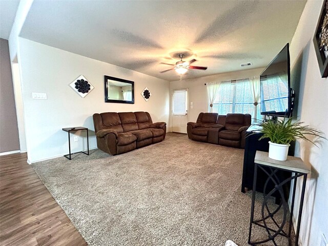 16410 Rodeo River Rd, Houston, TX 77049 - living area featuring ceiling fan, a textured ceiling, baseboards, and wood finished floors