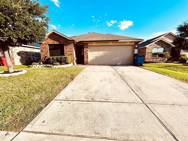 16410 Rodeo River Rd, Houston, TX 77049 - ranch-style home with brick siding, an attached garage, a front lawn, and driveway