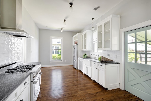 1316 Harvard St, Houston, TX 77008 - kitchen with high end appliances, wall chimney range hood, a sink, decorative backsplash, and dark wood-type flooring