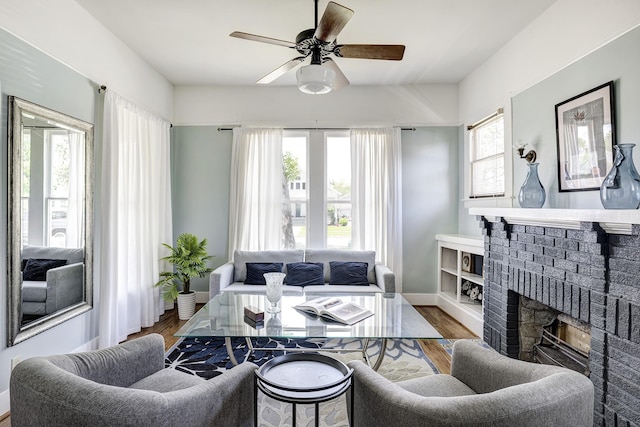 1316 Harvard St, Houston, TX 77008 - living area featuring a ceiling fan, wood finished floors, a fireplace, and baseboards