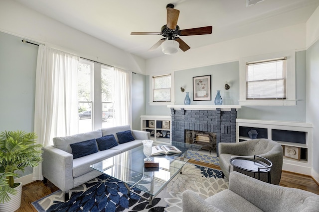 1316 Harvard St, Houston, TX 77008 - living area featuring ceiling fan, a brick fireplace, baseboards, and wood finished floors
