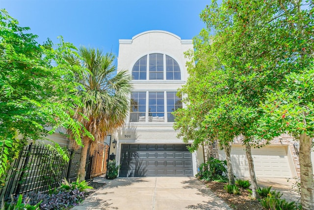 701 Asbury St, Houston, TX 77007 - view of front of property featuring driveway, a garage, and stucco siding