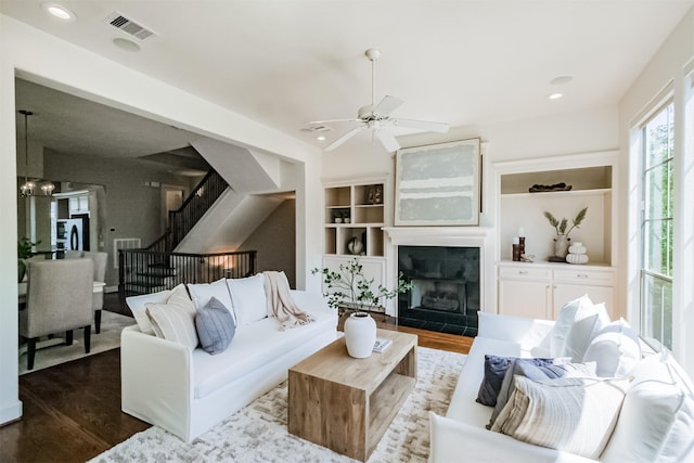 701 Asbury St, Houston, TX 77007 - living area featuring wood finished floors, stairs, built in shelves, ceiling fan, and recessed lighting