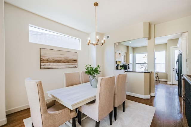 701 Asbury St, Houston, TX 77007 - dining space with dark wood-style floors, a chandelier, and baseboards