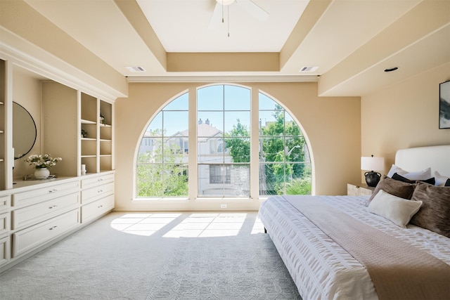 701 Asbury St, Houston, TX 77007 - carpeted bedroom with multiple windows, a tray ceiling, and ceiling fan