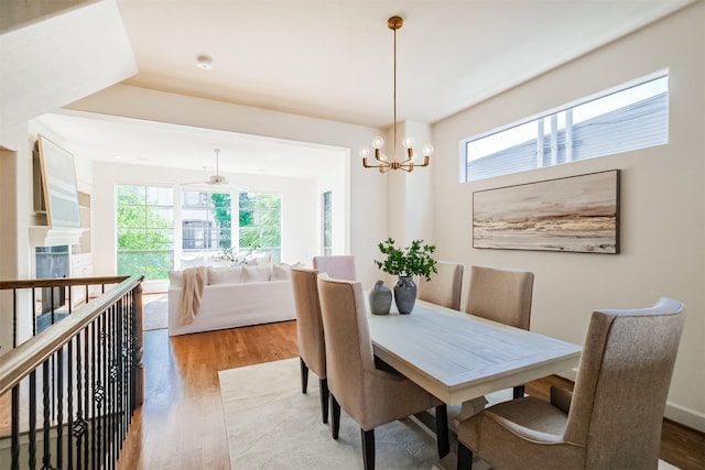701 Asbury St, Houston, TX 77007 - dining space with wood finished floors, a chandelier, and a ceiling fan