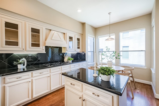 701 Asbury St, Houston, TX 77007 - kitchen featuring gas cooktop, premium range hood, tasteful backsplash, decorative light fixtures, and light wood finished floors