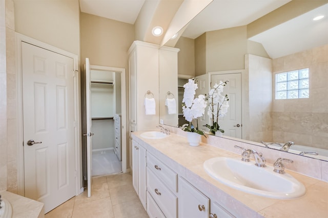 701 Asbury St, Houston, TX 77007 - full bathroom featuring double vanity, tile patterned floors, lofted ceiling, and a walk in closet