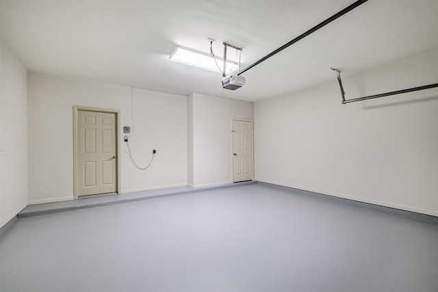 701 Asbury St, Houston, TX 77007 - garage with a garage door opener and baseboards