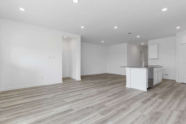 417 Amy St, Angleton, TX 77515 - kitchen featuring open floor plan, dark countertops, light wood-style flooring, stainless steel dishwasher, and recessed lighting