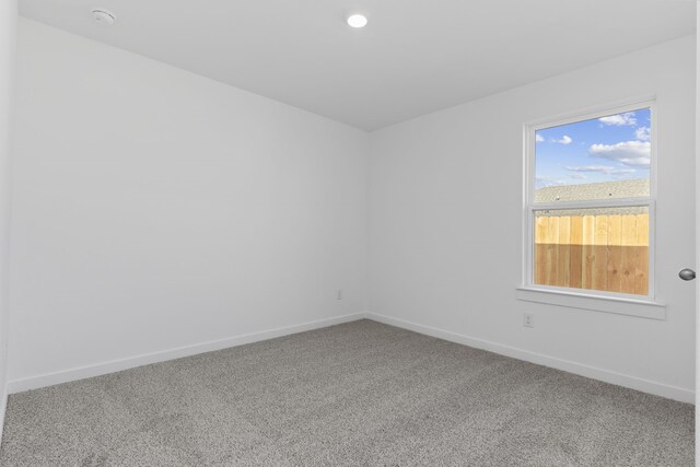 417 Amy St, Angleton, TX 77515 - empty room featuring carpet, baseboards, and a smoke detector