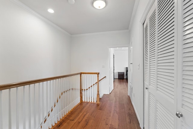 corridor featuring an upstairs landing, wood finished floors, crown molding, and recessed lighting
