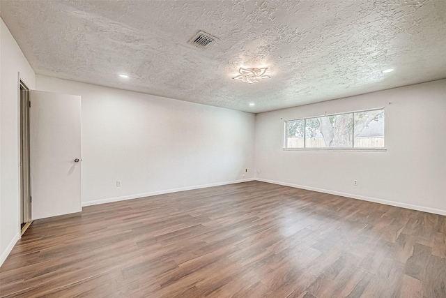 10806 Silkwood Dr, Houston, TX 77031 - spare room with a textured ceiling, wood finished floors, recessed lighting, and baseboards