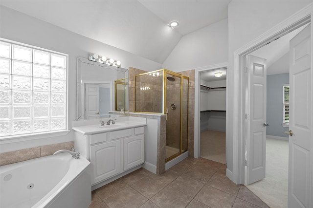 16503 Torry View Ter, Houston, TX 77095 - full bath with a stall shower, vaulted ceiling, vanity, a walk in closet, and tile patterned floors
