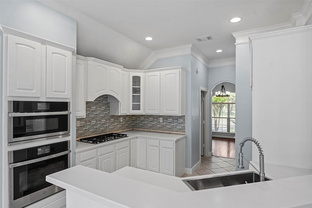 16503 Torry View Ter, Houston, TX 77095 - kitchen featuring stainless steel appliances, a sink, light tile patterned floors, white cabinetry, and crown molding