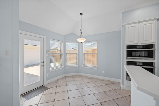 16503 Torry View Ter, Houston, TX 77095 - unfurnished dining area featuring lofted ceiling, healthy amount of natural light, light tile patterned floors, and baseboards