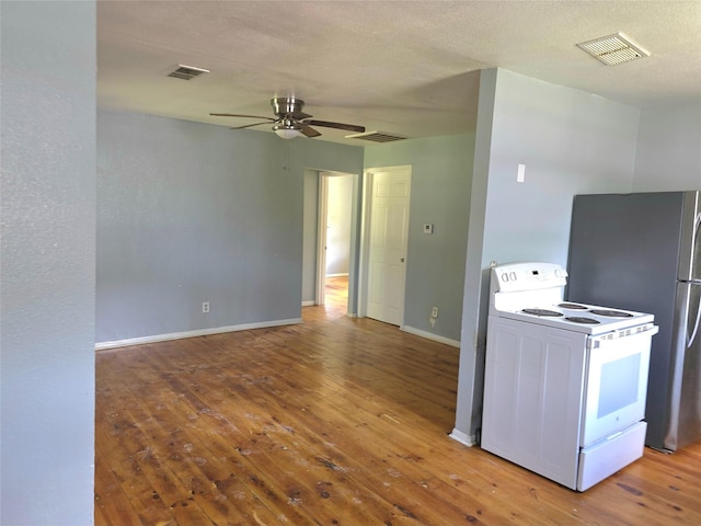 90 Oak Crest Dr, Shepherd, TX 77371 - kitchen featuring white electric range, hardwood / wood-style flooring, ceiling fan, baseboards, and freestanding refrigerator