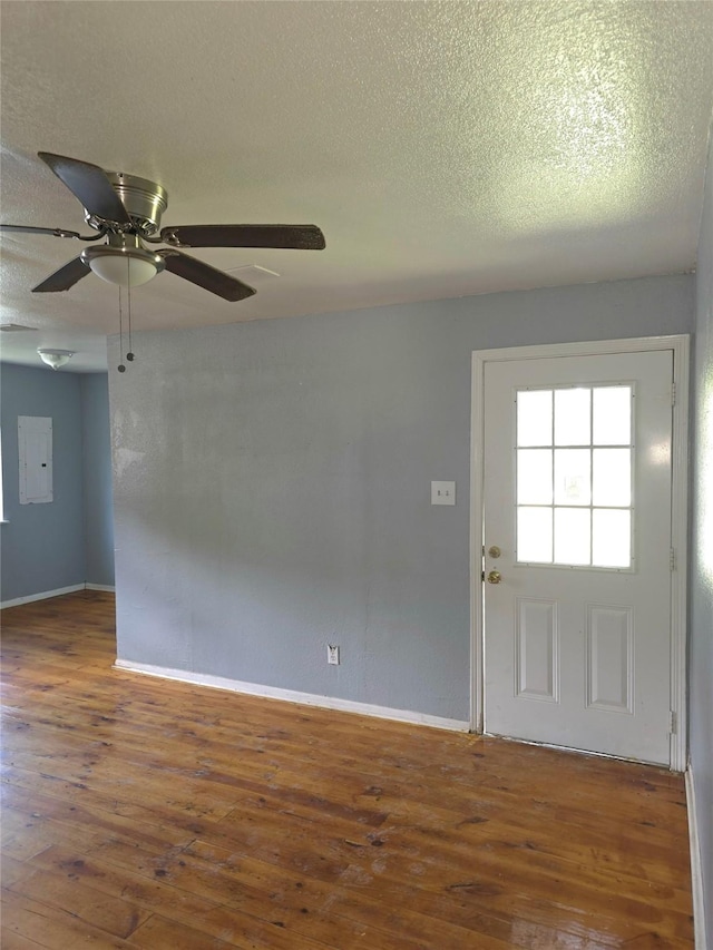 90 Oak Crest Dr, Shepherd, TX 77371 - unfurnished room featuring hardwood / wood-style flooring, baseboards, ceiling fan, and a textured ceiling