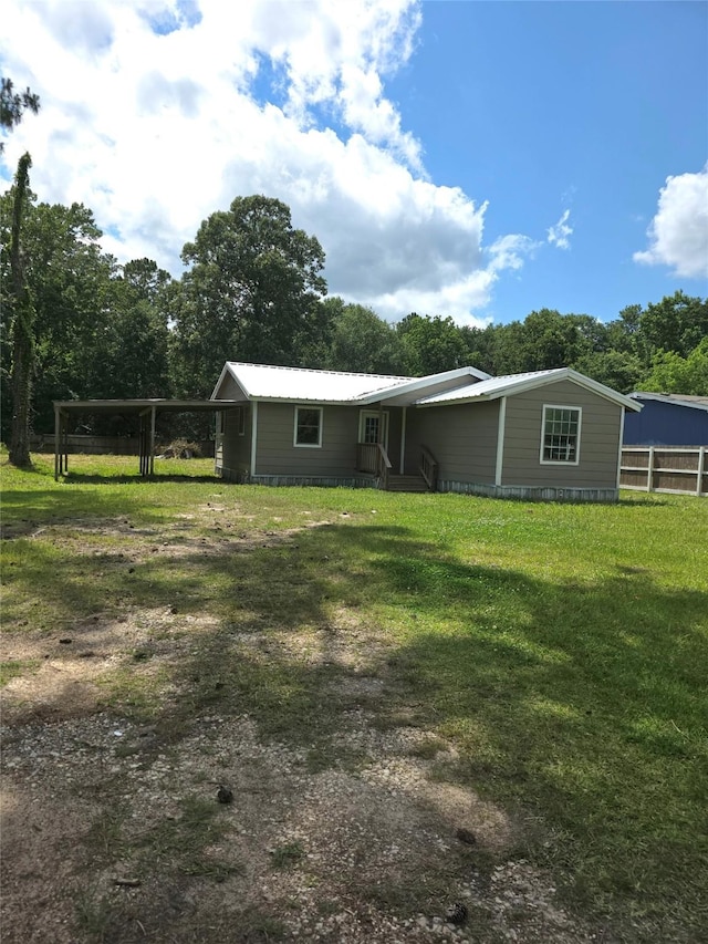 90 Oak Crest Dr, Shepherd, TX 77371 - back of house with a carport and a lawn