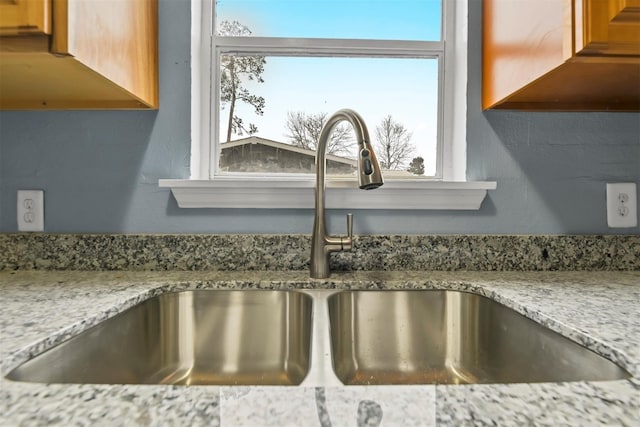 90 Oak Crest Dr, Shepherd, TX 77371 - kitchen view of a sink, brown cabinets, and light stone countertops