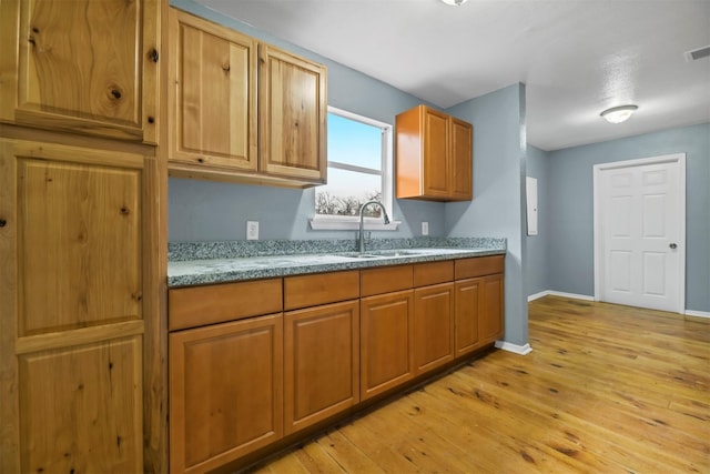 90 Oak Crest Dr, Shepherd, TX 77371 - kitchen with a sink, light wood-style floors, and brown cabinets