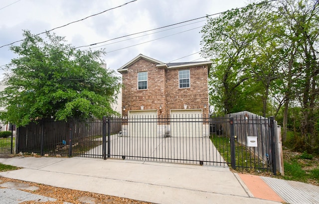 4915 Market St, Houston, TX 77020 - view of front facade featuring an attached garage, driveway, brick siding, and a fenced front yard