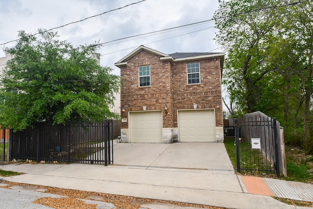 4915 Market St, Houston, TX 77020 - traditional-style house with concrete driveway, brick siding, a garage, stone siding, and a gate