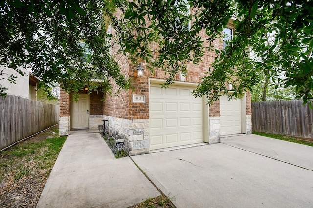 4915 Market St, Houston, TX 77020 - view of front of property featuring driveway, stone siding, and fence