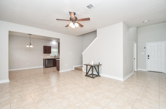 4915 Market St, Houston, TX 77020 - unfurnished living room featuring a ceiling fan, light tile patterned floors, baseboards, and a sink