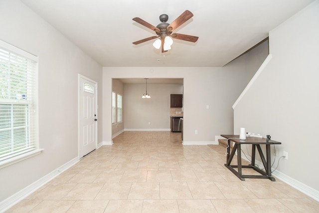 4915 Market St, Houston, TX 77020 - unfurnished room featuring ceiling fan, healthy amount of natural light, a chandelier, and baseboards