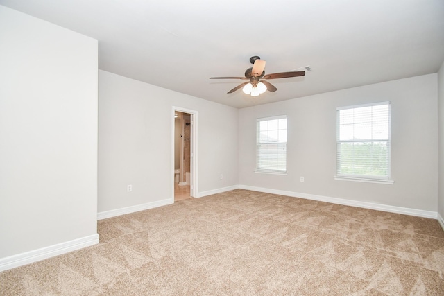 4915 Market St, Houston, TX 77020 - empty room featuring light carpet, a ceiling fan, and baseboards