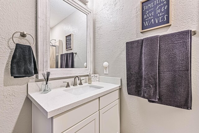 8111 Broadway St Unit 7, Galveston, TX 77554 - bathroom featuring a textured wall and vanity
