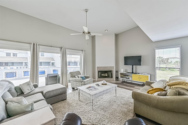 8111 Broadway St Unit 7, Galveston, TX 77554 - living area featuring a fireplace, wood finished floors, plenty of natural light, vaulted ceiling, and ceiling fan